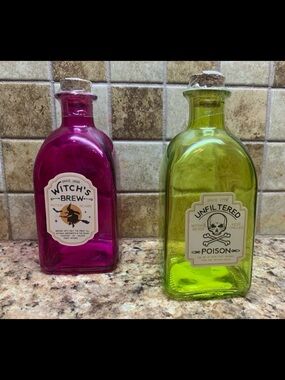 Decorative glass potion bottles with messages “Witch’s Brew” and “Unfiltered”